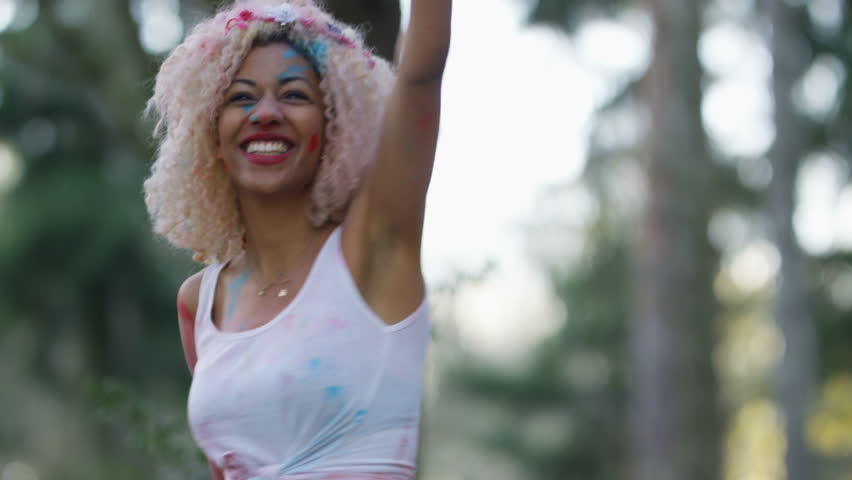 4K Happy hipster friends at music festival, dancing & throwing coloured powder. Shot on RED Epic.