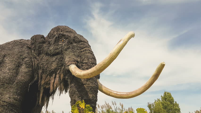 Mammoth prehistoric model at a park.
