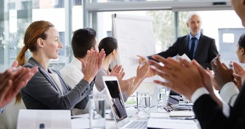 Business people applauding during a meeting in the office 4k