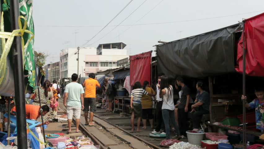 MAEKLONG, THAILAND - FEBRUARY 17, 2012: A train is going through the Maeklong
