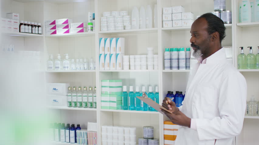 4K Portrait of friendly smiling worker in a chemist shop. Shot on RED Epic. | Shutterstock HD Video #20379622