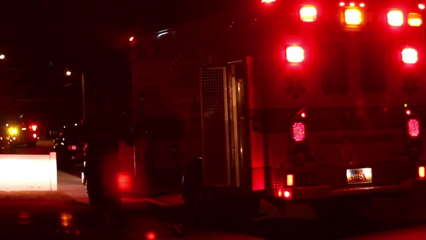 OREM, UTAH - CIRCA 2012: Emergency vehicle and EMT at scene of accident at night