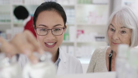 4K Worker in a chemist shop assisting mature lady. Shot on RED Epic.