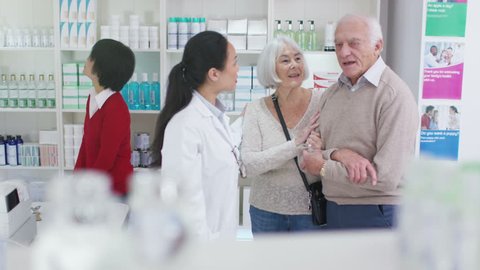 4K Worker in a chemist shop assisting elderly couple. Shot on RED Epic.