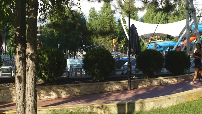 girl with cola walking in park