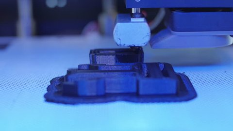 3D Printer frontal closeup printing a black piece