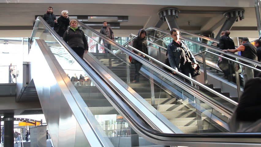 BERLIN - CIRCA APRIL 2011: Commuters descend an escalator at a Berlin metro