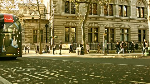 London, UK - 05.OCTOBER.2016: Charing Cross road with the view of the National Portrait Gallery, London. Early morning, the Sun just risen, people passing , traffic on the road.