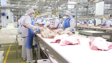 People prepare fresh meat for delivery to stores.
