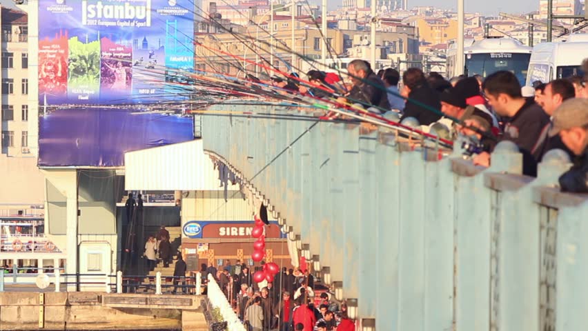 ISTANBUL - JANUARY 04: People are fishing on Galata Bridge of Goldenhorn on