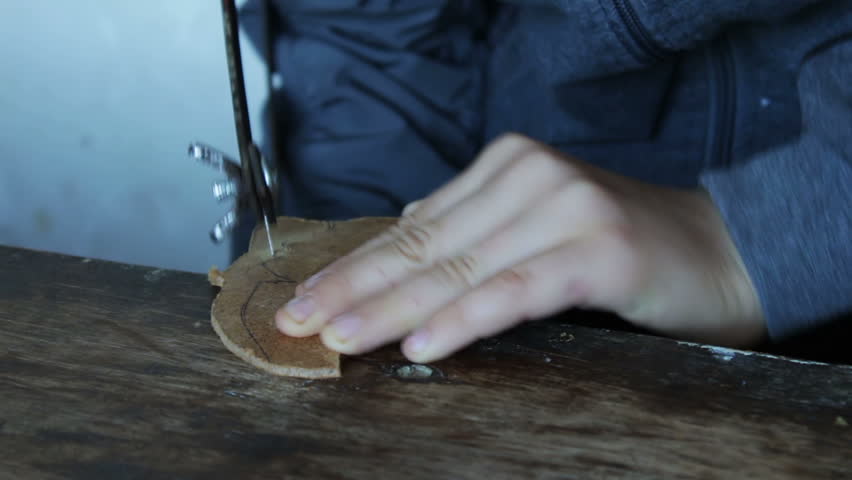 Little handsaw sawing wood veneer