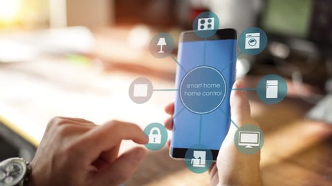 Smart Home - Man using smart home app on a smart phone. Smart home, intelligent house automation remote control concept. The Internet of things