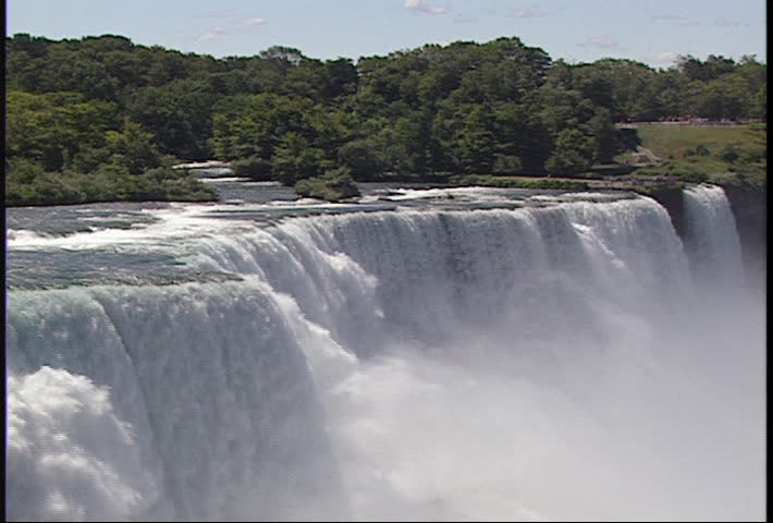 Slight, slow zoom out reveals the American side of Niagara Falls
