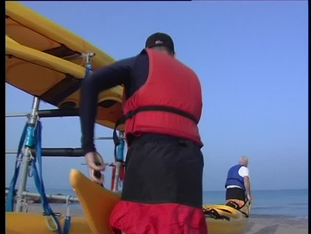 two person are unloading a canoe
