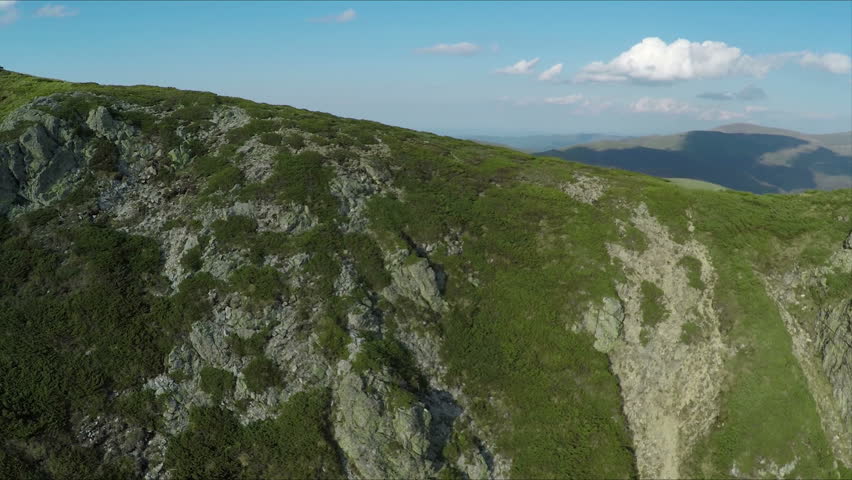 Aerial view of high mountain side, sunset light