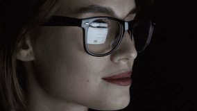 Pensive businesswoman in eyeglasses looking at computer screen 