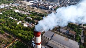 Flue-gas stack tower of thermal power station HD aerial video. Air pollution of urban industrial area landscape. 
