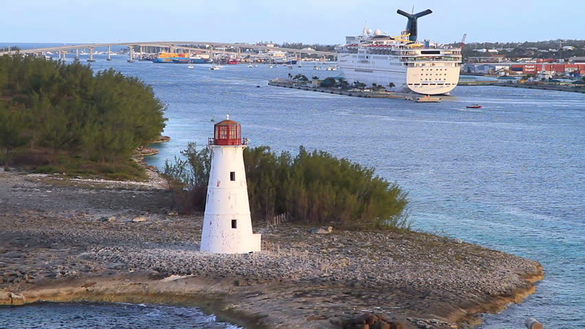 lighthouse on island at sunset, cruise ship background