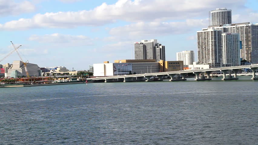 Cityscape, Miami skyline with bridge, from over the water angle, panning view