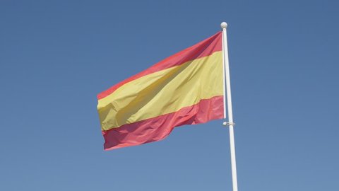 National symbol of Spain on flagpole against blue sky 4K 2160p 30fps UltraHD footage - Famous Spanish red and yellow flag stripes on the wind 4K 3840X2160 30fps UltraHD video