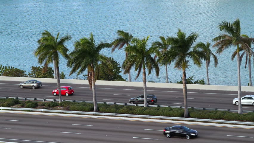 cars driving on the expressway/highway by the ocean, in Miami, aerial view