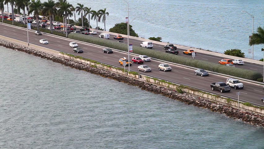 cars driving on the expressway/highway by the ocean, in Miami, aerial view