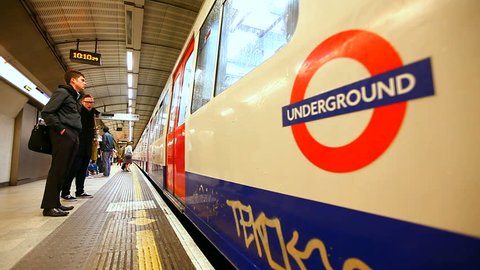 Londoon, England- July 18, 2016-  London underground subway train station time-lapse, train arrives & unidentified crowds of people move to disembark & embark the train, London 