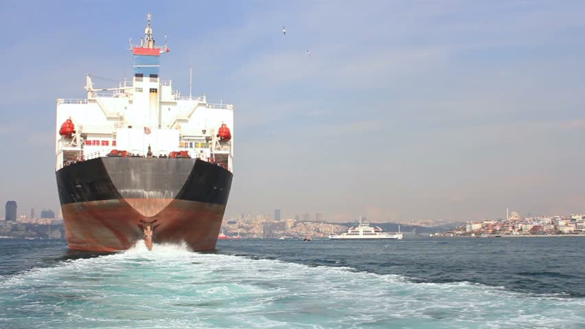 Large ship sailing through Straits in Istanbul, Turkey. Back view of the oil