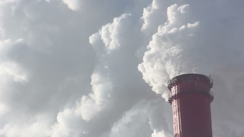 Industrial chimney belching out clouds of smoke into the atmosphere in an air