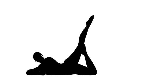 Girl shows the pose shadoof with outstretched leg. Silhouette