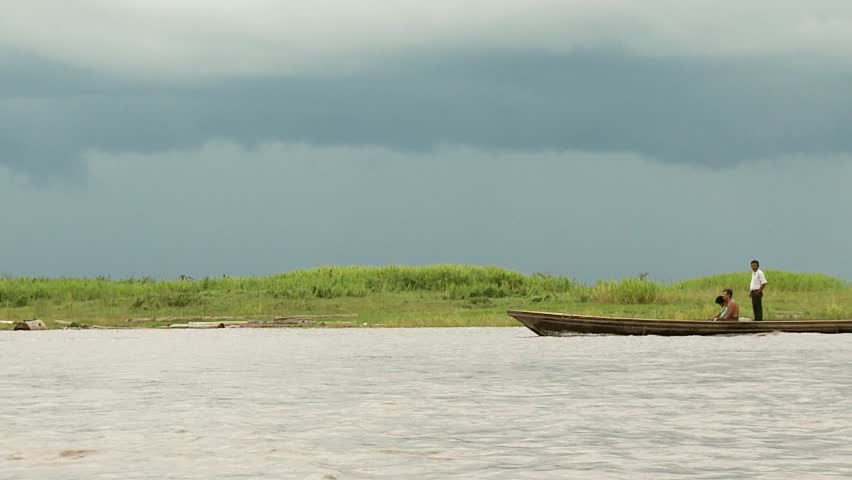 Men travel in a boat on Amazon River circa November 2011 in Iquitos, Peru.