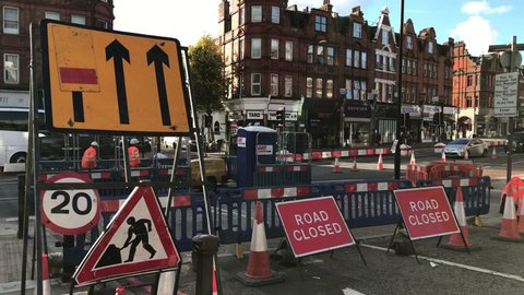 LONDON - OCTOBER 18: Roadworks and signs at a junction on the Finchley Road on October 18, 2016 in North London, UK.