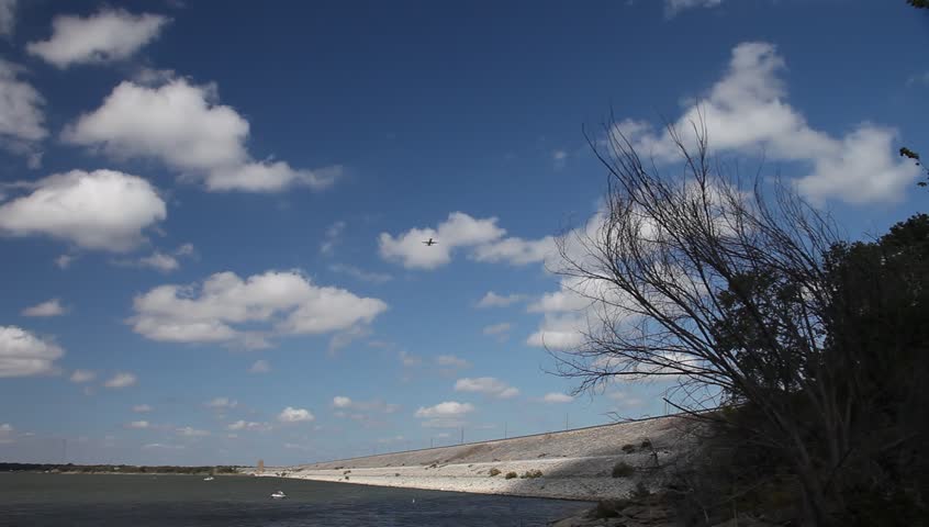 Airplane landing at airport flying over Grapevine Lake in Grapevine Texas.