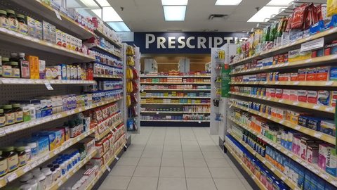 MONTREAL, CANADA - OCTOBER 2016: Smooth & steady slow motion shot inside pharmacy (Vitamins, supplements & then prescription drugs)