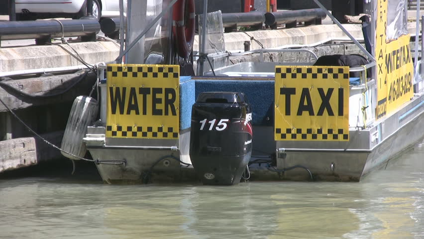A water taxi boat tied to a dock.