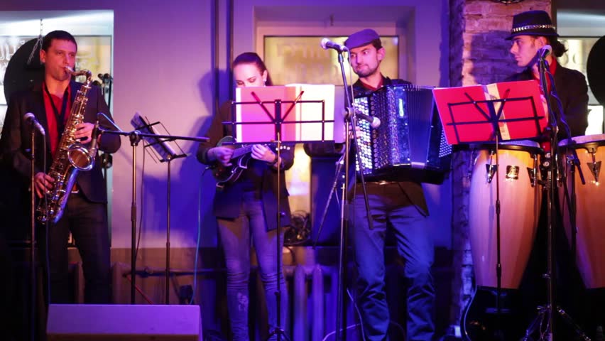 Five musician of band is playing music at musical bar.