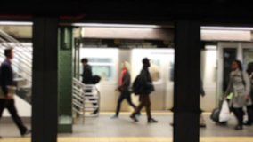 Horizontal HD clip of commuters in a New York subway station, blurred to prevent identification.