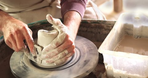 Mid section of potter making pot in pottery workshop 4k