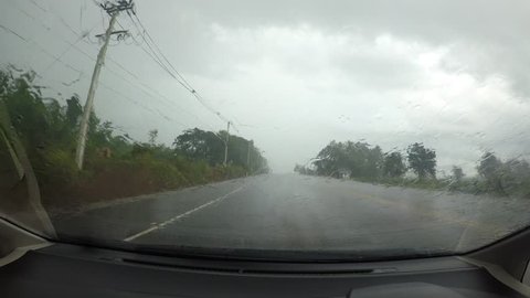 Driving a Car on a Country Road  windshield. Day, with rain