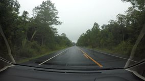 Driving a Car on a Country Road  windshield. Day, with rain