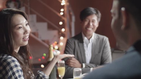 Beautiful Japanese women talks to two men at christmas dinner party ஸ்டாக் வீடியோ