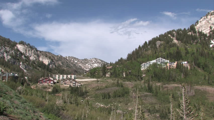 Resorts in Wasatch Mountain valley of Alta and Snowbird Utah.  Pan right valley. Forests just outside of Salt lake City, Utah. Luxury residence, timeshare, hotel and resorts for the rich and famous.