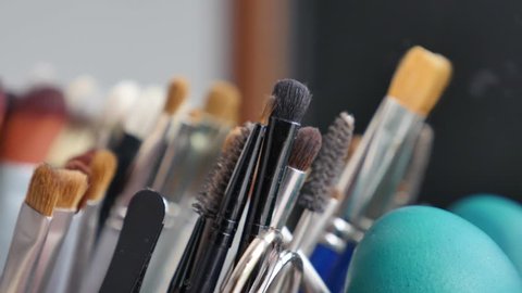 A lot of professional make-up brushes on a table, the shot is moving from right to left...