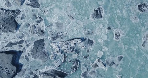Aerial view of a glacier huge pieces of frozen ice and rock, top view  