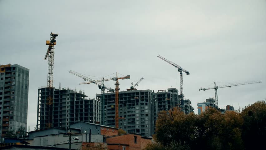 Time lapse of constuction site with many cranes building many highrise apartment blocks