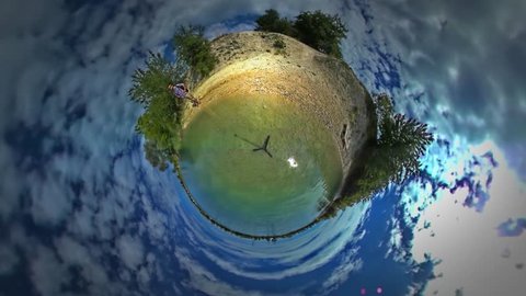 Tiny Little Planet 360 Degree Timelapse. Man at the Sea, Looking at Turquoise Water. Tourist is Walking Along River, Standing on Sandy Lake Bank, Seaside. Backpacker, Man is Traveling in Warm a