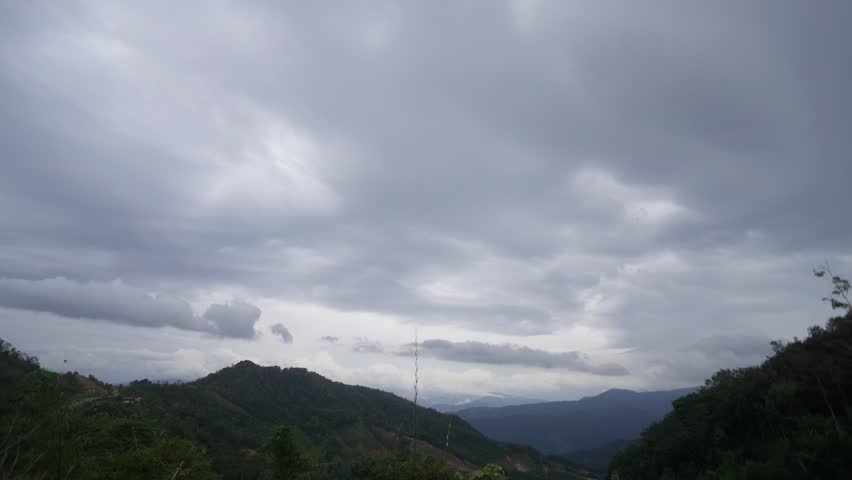 Time lapse of dramatic cloud storm over hilly landscape valley of beautiful Sabah Malaysian Borneo.