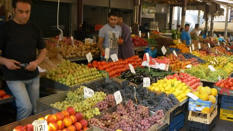 ATHENS, GREECE- SEPTEMBER, 16, 2016: walking past fruit and vegetable stalls in the central market of athens, greece