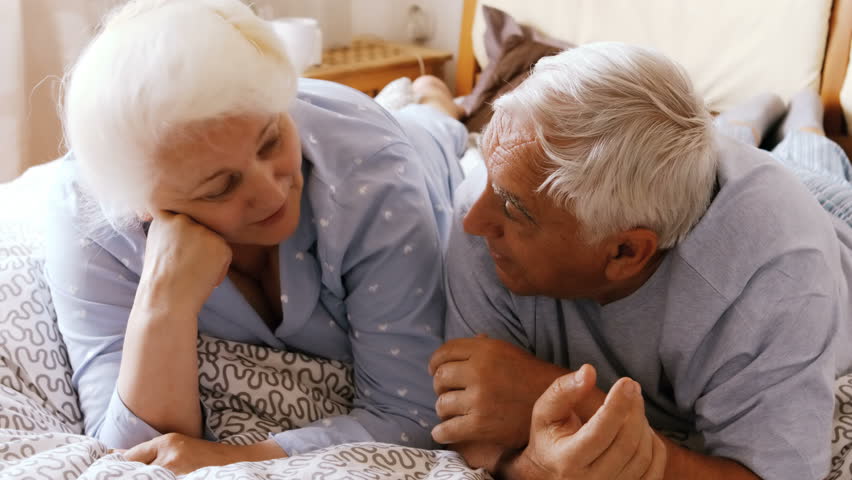 Senior Caucasian couple interacting while relaxing on bed in bedroom 4k | Shutterstock HD Video #20550310