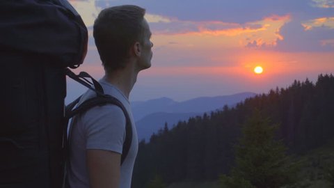 3 in 1 video! The handsome man stand on the mountain against the background of sunset. Real time capture. Wide angle  Video Stok